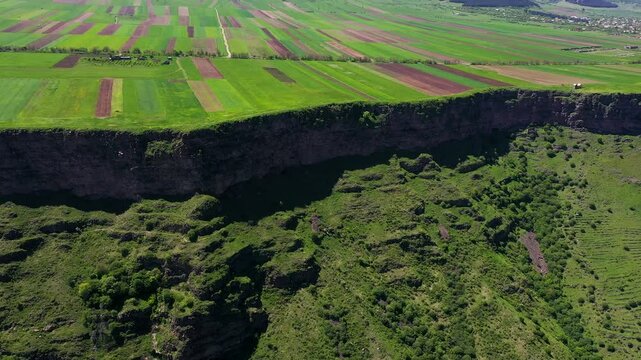 4K aerial drone footage of Horomayr Monastery perched on Debed River Canyon cliffs, with vibrant fields between Odzun and Aygehat villages in Lori Province, Armenia. A blend of history and nature!