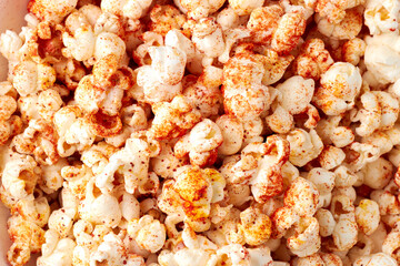 Spicy popcorn with chili powder covering creates delicious snack