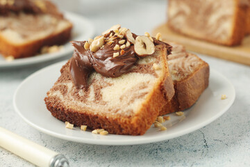 A piece of marble biscuit with chocolate cream and nuts	