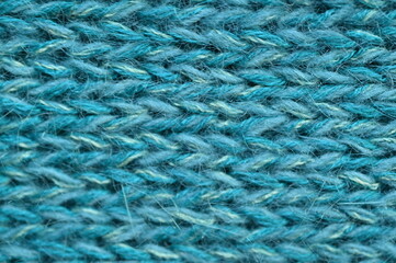 turquoise  texture of knitted wool fabric as a background, teal smooth symmetrical lines of hand-knitted needlework pattern	
