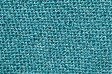 turquoise  texture of knitted wool fabric as a background, teal smooth symmetrical lines of hand-knitted needlework pattern	

