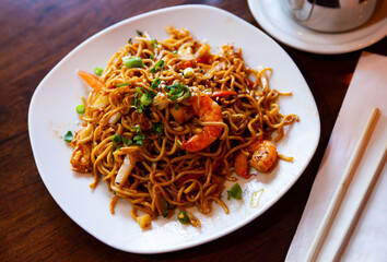 Traditional Japanese noodles with shrimp, vegetables and teriyaki sauce..