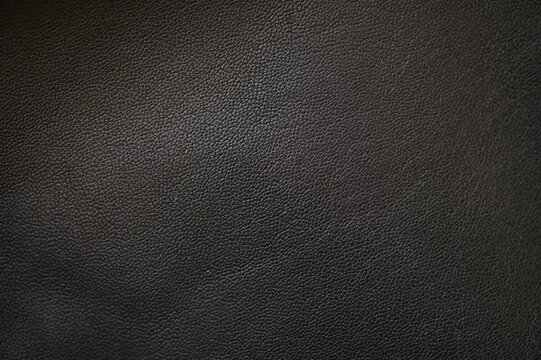 black leather texture close-up, seams on leather jacket as background, black natural leather as background, black leather stitching