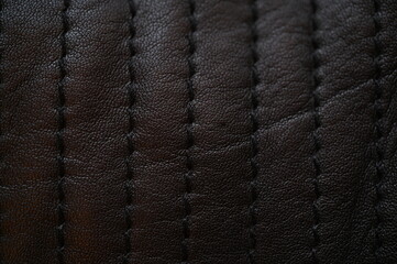 black leather texture close-up, seams on leather jacket as background, black natural leather as background, black leather stitching