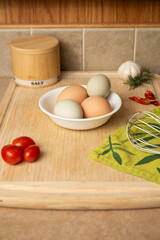 Fresh eggs on counter with whisk portrait