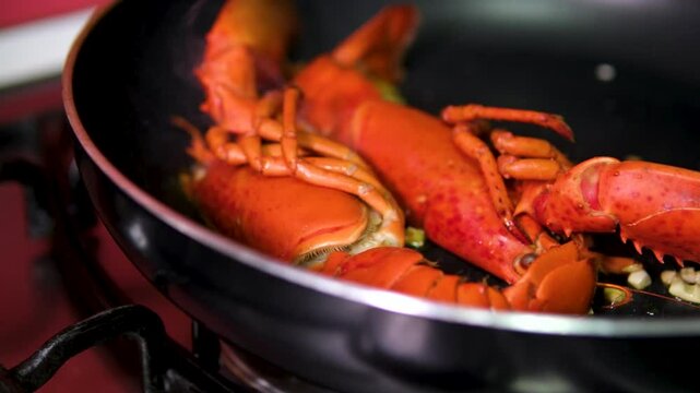 Lobster frying pan Close up of cooking spiny lobsters steaming on a frying pan on an electric stove. The most popular seafood dishes of the Caribbean cuisine 