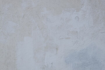 A fire hydrant sits in front of a plain white wall, providing a simple and clean visual.
