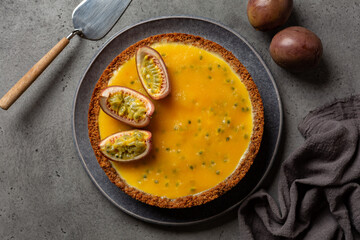 Top view of Vanilla Cheesecake with mango and passion fruit gelatin topping. Homemade fruit baked...