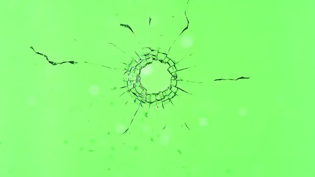 Super Slow Motion of Shattered Glass Isolated on Green Background. Break Glass from the Gunshot. Filmed on High Speed Cinema Camera, 1000 fps.