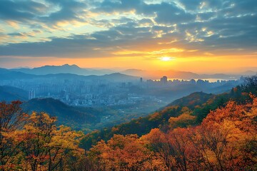 Beautiful sunrise over the cityscape and mountains during autumn season
