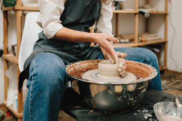 Process of making a unique ceramic shape. Potter creates a ceramic bowl in the pottery studio.