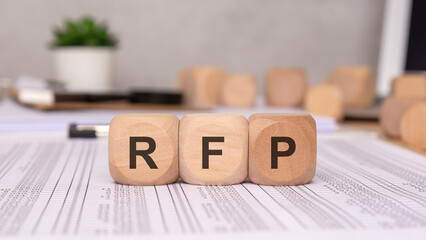 RFP- Request For Proposal word written on a wooden block with calculator, business concept