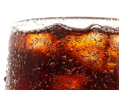 A close-up of overflowing cola fizz, bubbly and dark brown, cascading over the edge of an invisible glass, sparkling carbonation with tiny bubbles rising.
