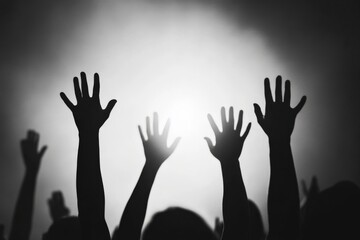 Silhouette of Raised Hands in a Crowd