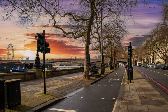 The River Thames, the Waterloo Bridge, the London Eye Ferris wheel with skyscrapers and office buildings in the city skyline and truck on the street in Westminster England UK