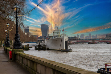 The River Thames, boats and ships, skyscrapers and office buildings in the city skyline in Westminster England UK