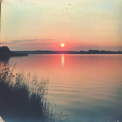 Naklejka premium Sunset over serene lake in Poland.