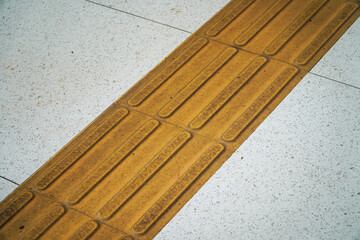A close-up view of tactile paving, providing safe guidance for visually impaired pedestrians. Tactile Paving for Visually Impaired. Tactile Paving: A Guide for the Visually Impaired