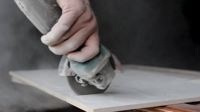 Close-up of cutting ceramic tile with an angle grinder (flex) against a black background. The video highlights precision and skill in tile cutting, ideal for construction and renovation projects.