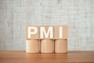 There is wood cube with the word PMI. It is an abbreviation for Post Merger Integration as...