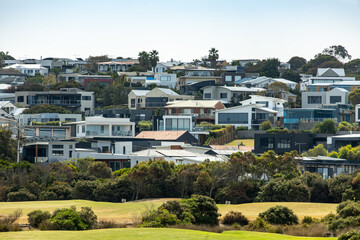 a coastal hillside community in Torquay, Victoria, with numerous modern homes and contemporary...