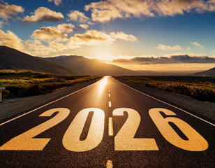A long, open road stretches into the horizon at sunset, with “2026” boldly painted on the asphalt, symbolizing the journey ahead.