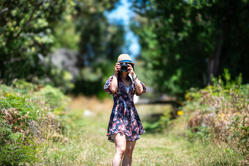Young woman taking photos on the footpath, Wilsons Promontory National Park, Victoria, Australia