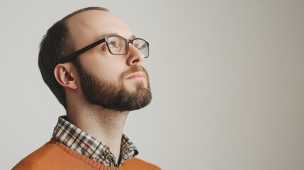 Fototapeta premium Thoughtful Man Gazing Upward, Copy Space, Beard and Glasses