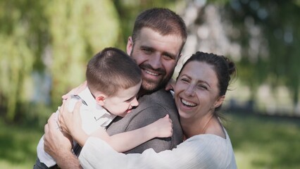 Fototapeta premium A joyful and happy family happily enjoying a beautiful sunny day outdoors, showcasing love and togetherness
