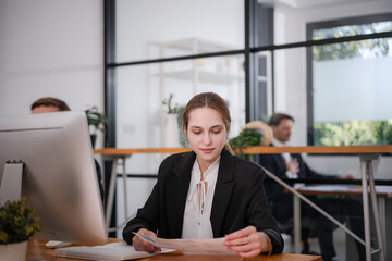 Businesswoman sitting and analyzing business performance in office
