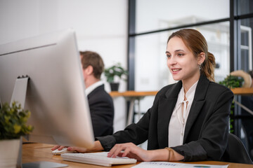 Businesswoman sitting and analyzing business performance in office