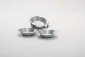 Small metal moulds for making fruit tartlets.