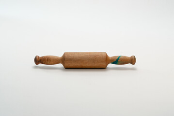 Small wooden rolling pin on a white background.