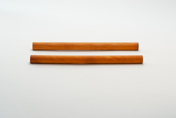 Two cylindrical pieces of wood for flattening raw dough.