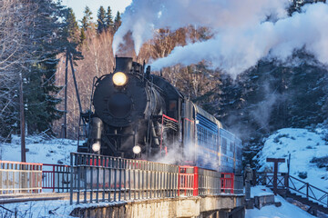 Retro train moves above the river.
