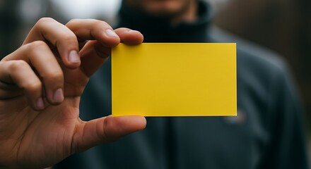 Hand holding yellow blank card - Opportunity or warning - Business presentation