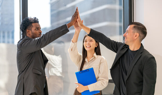 Successful of group professional business people to win of celebrating project success.Creative business giving hi five good teamwork, success, happiness, achieving goals, target, profit at office
