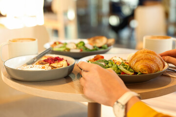 Woman having tasty breakfast in cafe, closeup