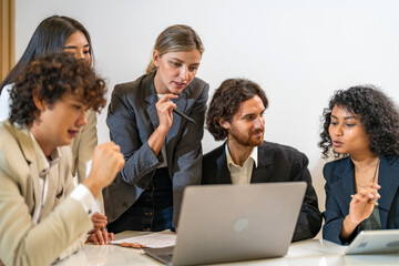 Diverse team brainstorming business meeting, professional presentation with data charts, team collaboration for project planning, modern corporate office teamwork, group discussing business strategies