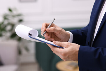 Real estate appraisal. Inspector with clipboard conducting property valuation indoors, closeup