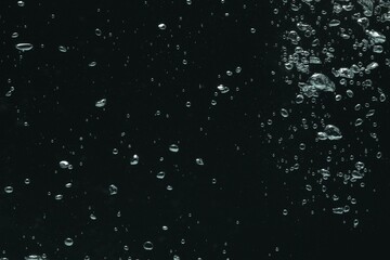 Many water bubbles on black background, closeup