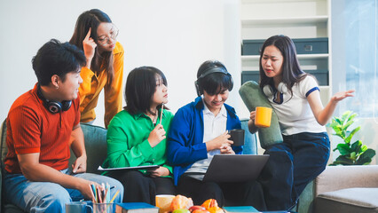 Five young Asian students engage in online study on campus, collaborating on research, projects....