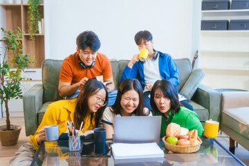 Five young Asian students engage in online study on campus, collaborating on research, projects. They help each other with assignments, gaining valuable experience and preparing for future careers.