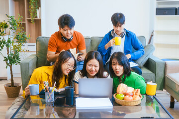 Five young Asian students engage in online study on campus, collaborating on research, projects. They help each other with assignments, gaining valuable experience and preparing for future careers.
