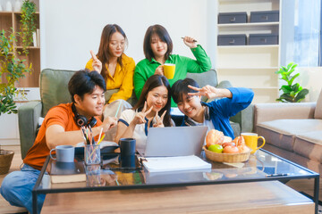 Five young Asian students engage in online study on campus, collaborating on research, projects. They help each other with assignments, gaining valuable experience and preparing for future careers.