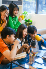 Five young Asian students engage in online study on campus, collaborating on research, projects. They help each other with assignments, gaining valuable experience and preparing for future careers.