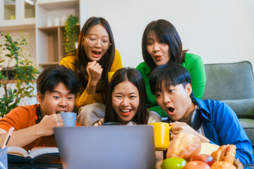 Five young Asian students engage in online study on campus, collaborating on research, projects. They help each other with assignments, gaining valuable experience and preparing for future careers.