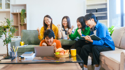 Five young Asian students engage in online study on campus, collaborating on research, projects. They help each other with assignments, gaining valuable experience and preparing for future careers.