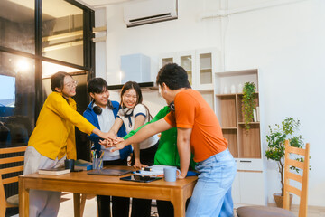 Fototapeta premium Five young Asian students engage in online study on campus, collaborating on research, projects. They help each other with assignments, gaining valuable experience and preparing for future careers.