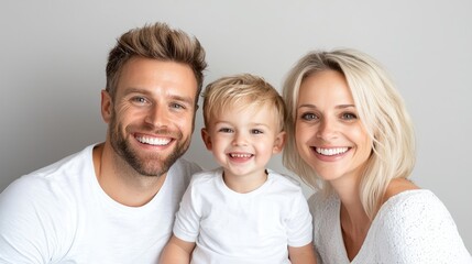 Fototapeta premium Happy family portrait, smiling parents and child, studio shot, for use in family/parenting material